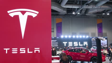 The-American-electric-company-car-Tesla-Motors-booth-and-logo-during-the-International-Motor-Expo-showcasing-thermic-and-EV-electric-cars-and-motorcycles-in-Hong-Kong