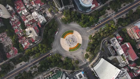 Roundabout-of-angel-of-independence-on-aerial-footage-on-cenit-during-cars-cross-the-avenue-in-the-morning-on-reforma-avenue-street