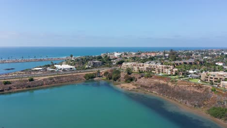 Aerial-view-of-the-coastal-city-Carlsbad-and-beachfront-houses-looking-over-the-sea