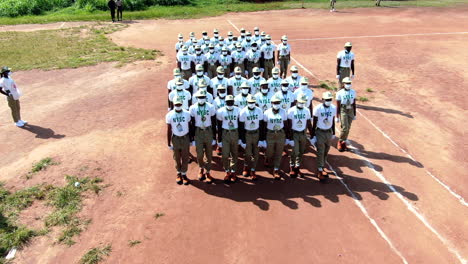 Uniformed-youth-at-a-National-Youth-Services-Corps-permanent-orientation-camp-marching-in-formation---aerial-view
