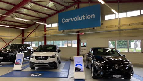 Slow-panning-shot-of-three-cars-ready-to-be-delivered-to-new-customers-at-Carvolution-HQ-in-Bannwil,-Switzerland