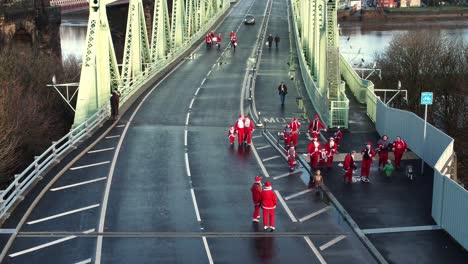 Charity-Santa-dash-fun-run-over-Runcorn-Silver-Jubilee-bridge-Aerial-view-zoom-in-slowly