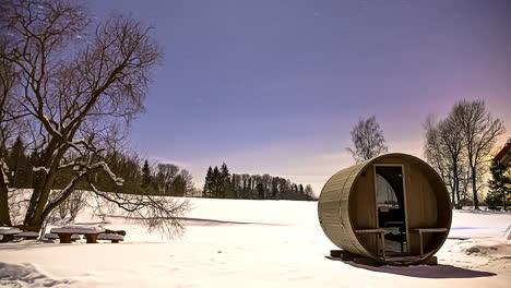 Time-lapse-barrel-sauna-sunset-snowy-landscape