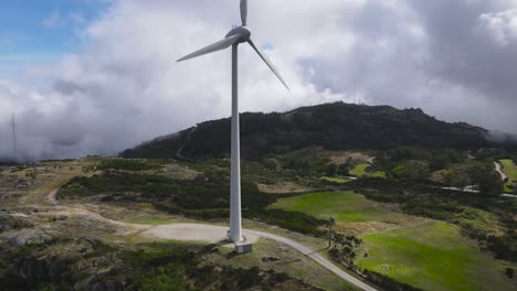 Wind-turbine-for-eolic-energy-production-on-green-mountain-of-Caramulo,-Portugal