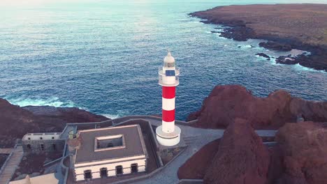 Lighthouse-building-in-Tenerife-with-majestic-ocean-view,-aerial-drone-shot