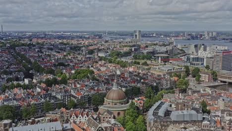 Amsterdam-Netherlands-Aerial-v6-drone-fly-around-koepelkerk-capturing-surrounded-downtown-cityscape-and-canal-system-at-binnenstad-and-grachtengordel-west-neighborhoods---August-2021