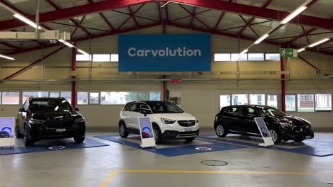 Dolly-shot-of-three-cars-ready-to-be-delivered-to-new-customers-at-Carvolution-HQ-in-Bannwil,-Switzerland