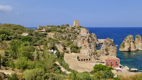 Unique-panoramic-view-of-Stacks-or-Faraglioni-of-Scopello-with-Tonnara-or-tunnery-and-Torre-Doria-watchtower-in-Sicily