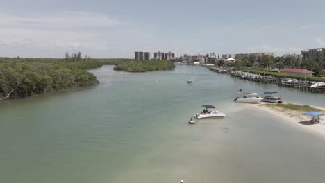 Aerial:-Locals-beat-the-Florida-heat-in-Broadway-Channel,-Bonita-Beach