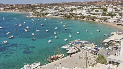 Aliki-Paros-Greece-Aerial-v3-birds-eye-view-capturing-seaside-and-hillside-fishermen-village-with-fishing-boats-moored-on-beautiful-clear-blue-aegean-sea---September-2021