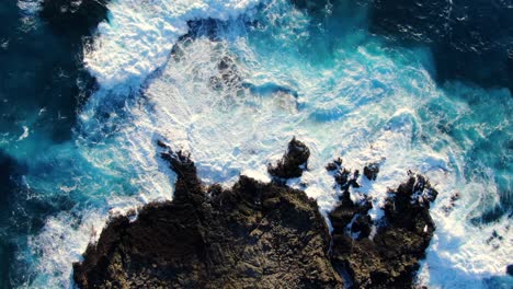 drone-ascending-above-rocky-shore-as-waves-crash-on-the-reef