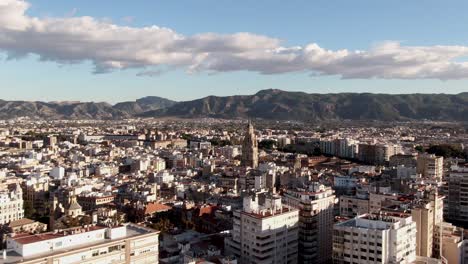 Aerial-view-of-Murcia-City-and-Cathedral-with-a-mountain-backdrop,-Spain