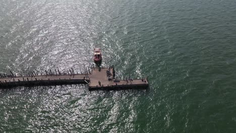 Aerial-steady-footage-of-this-Pattaya-Fishing-Dock-with-a-fishing-boat-docked-from-a-high-altitude,-Pattaya,-Thailand