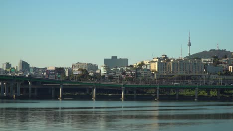 Han-river-near-Hannam-bridge,-Namsan-N-Seoul-tower-and-traffic-on-Gangbyeon-highway-road---wide-angle,-static