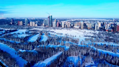 Winter-Aerial-flight-forward-over-cross-country-skiing-park-towards-the-most-luxurious-residential-real-estate-in-the-Edmonton-Westside-from-116th-St-NW-to-125th-St-NW-at-the-rivers-edge-park-G1-2