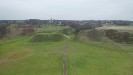 AERIAL:-Kernave-Medieval-Capital-with-Green-Mounds-in-Autumn