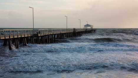 Waves-crashing-into-jetty,-pier-in-slow-motion
