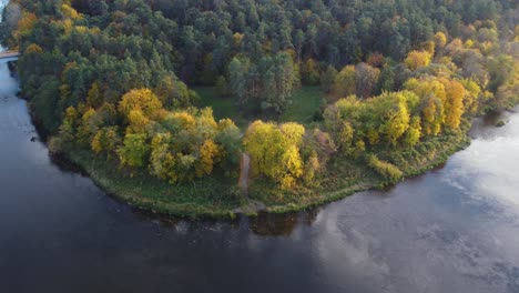 AERIAL-Orbiting-Shot-of-a-River-Bend-with-Vibrant-Autumn-Foliage-in-October