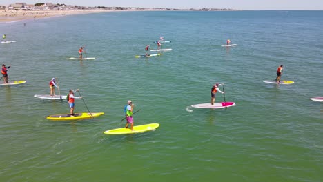 Paddleboarders-propelling-their-boards-during-racing-event-at-Duxbury-beach