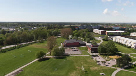 City-park-and-living-district-with-apartment-buildings-of-Norrkoping,-aerial-drone-view