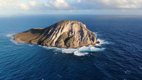 Drone-tilting-up-from-ocean-to-a-small-uninhabited-island-in-Hawaii