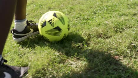 Slow-motion-view-of-an-African-American-soccer-player-with-the-ball-on-the-football-pitch