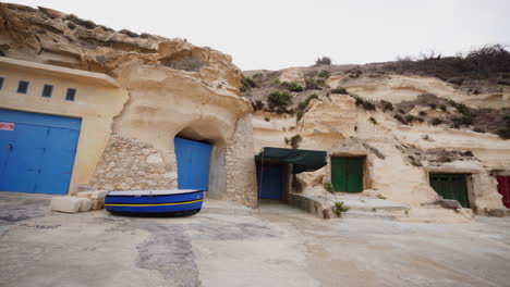 Deserted-dock-during-winter-on-island-of-Gozo,-rock-buildings