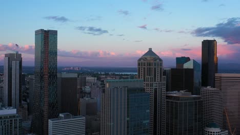 Aerial-pushing-in-on-Seattle's-unique-downtown-skyscrapers-at-sunset