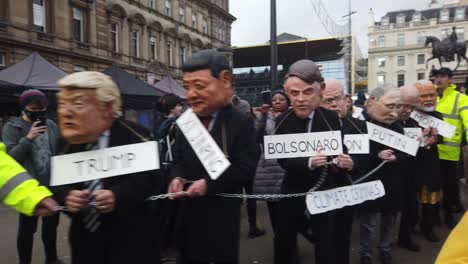 Protesters-dressed-up-as-World-leaders-being-led-through-George-Square