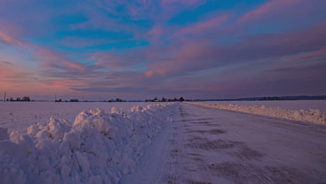 Time-lapse-shot-of-snowy-winter-landscape-with-moving-clouds-at-blue-sky-during-golden-hour---5K-prores-footage