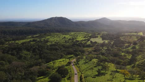 Drone-shot-following-a-car-through-insane-Costa-Rican-green-landscape