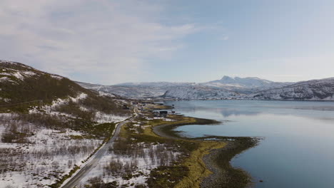Scenic-road-along-Daafjord-through-snowy-landscape,-Ringvassoya