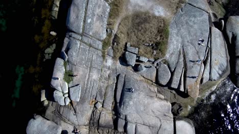 Aerial-Birds-Eye-View-Over-Granite-Rocks-Beside-Punta-Cabalo-Lighthouse-On-Arousa