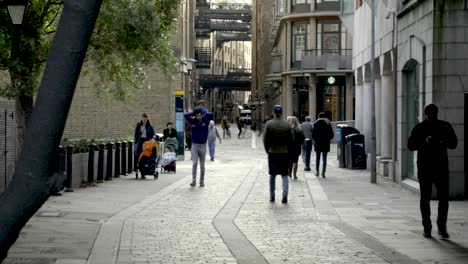 People-walk-on-the-busy-street-in-the-city-center-of-London,-United-Kingdom