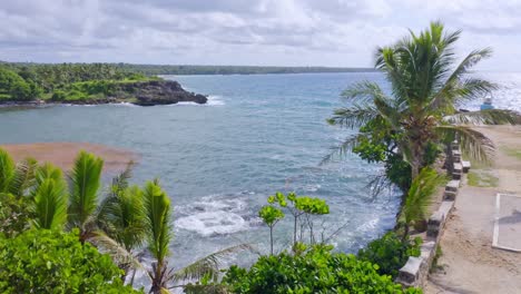 Seascape-Rising-Drone-View-Over-Clifftop-of-Boca-De-Yuma-Rugged-Coastline-on-a-Windy-Day,-Dominican-Republic