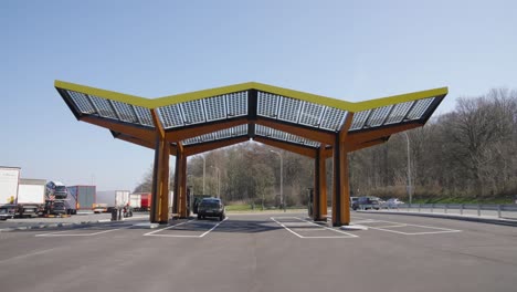 Coche-Eléctrico-Cargando-La-Batería-En-Una-Estación-De-Carga-Eléctrica-Con-Panel-Solar---Lovaina,-Bélgica