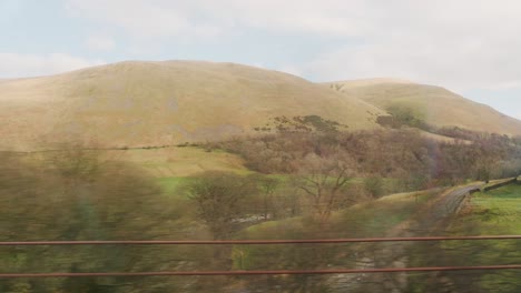 Mountain,-Meadow,-And-Countryside-Town-From-Train-Traveling-At-Daytime