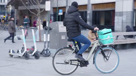 Deliveroo-rider-searching-dark-store-to-pick-up-food-order-for-fast-flash-delivery---Brussels,-Belgium