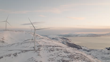 Wind-Turbine-Producing-Renewable-Energy-In-Fjord-Landscape,-Aerial