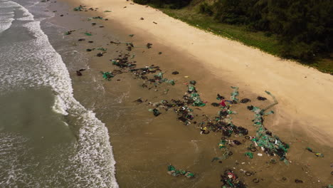 Aerial-top-down-shot-of-dirt-and-waste-at-sandy-beach-after-Typhoon-Rai---orbit-shot