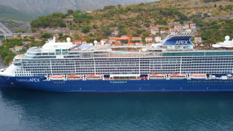 Celebrity-Apex,-Edge-class-Cruise-Ship-At-Dubrovnik-Cruise-Port-In-Croatia---aerial