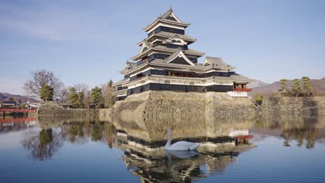 Matsumoto-Castle-on-Winter-Day,-Castle-Reflecting-on-Moat,-Establishing-Shot