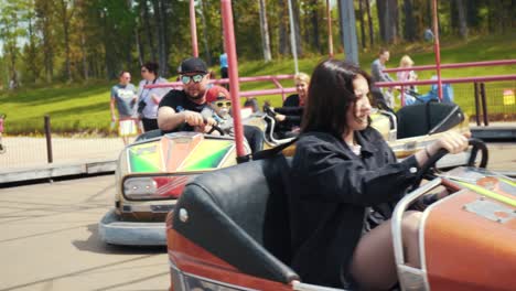 Ledmane-Parish,-Latvia---May-30,-2021:-Amusement-Park-Abpark-People-Ride-Multicolored-Electric-Cars-in-the-Autodrome-and-Have-Fun