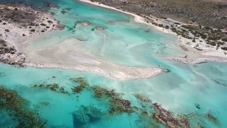 Aerial-drone-panoramic-view-video-of-famous-exotic-paradise-sandy-deep-emerald-beach-of-Elafonissi-in-South-West-Crete-island,-Greece