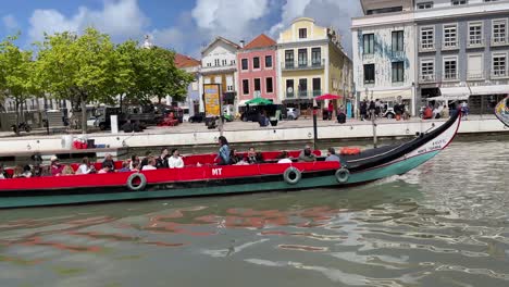 Tourists-on-a-moliceiro-boat-sail-along-the-central-canal-of-Ria-de-Aveiro