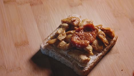 Putting-Pizza-Sauce-On-Top-Of-Fried-Chicken-Breast-In-Whole-Grain-Toast