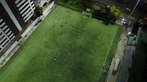Soccer-players-play-a-friendly-match-on-a-field-next-to-the-street
