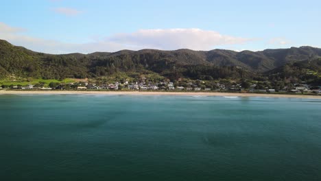 Aerial-view-of-secluded-beach-town-in-New-Zealand