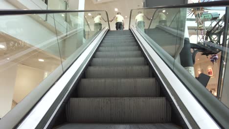 Riding-up-on-an-escalator-in-an-office-building,-point-of-view