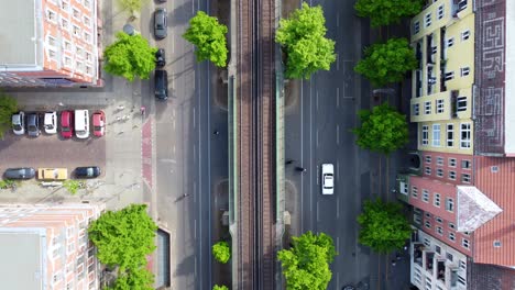 Pedestrians-cross-the-street-elevated-train-car-passes